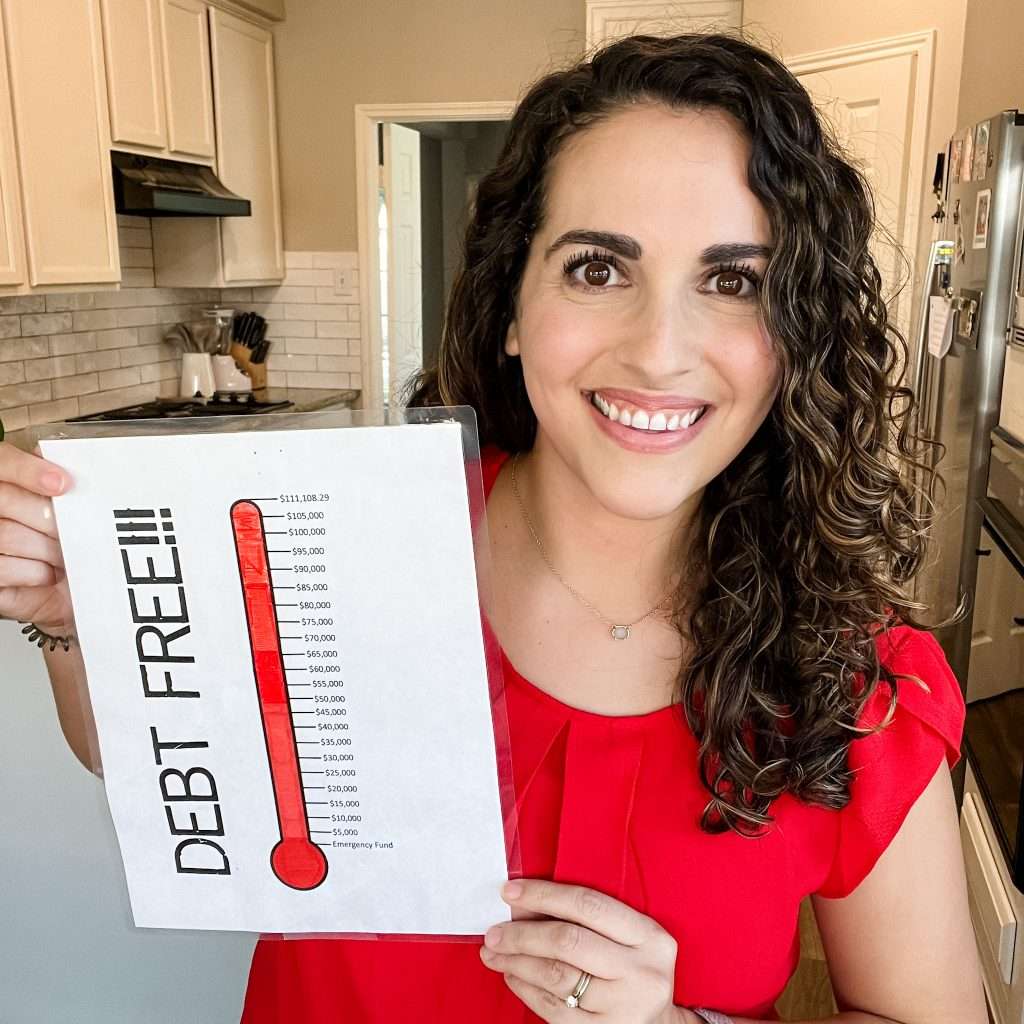 Woman holding debt free thermometer