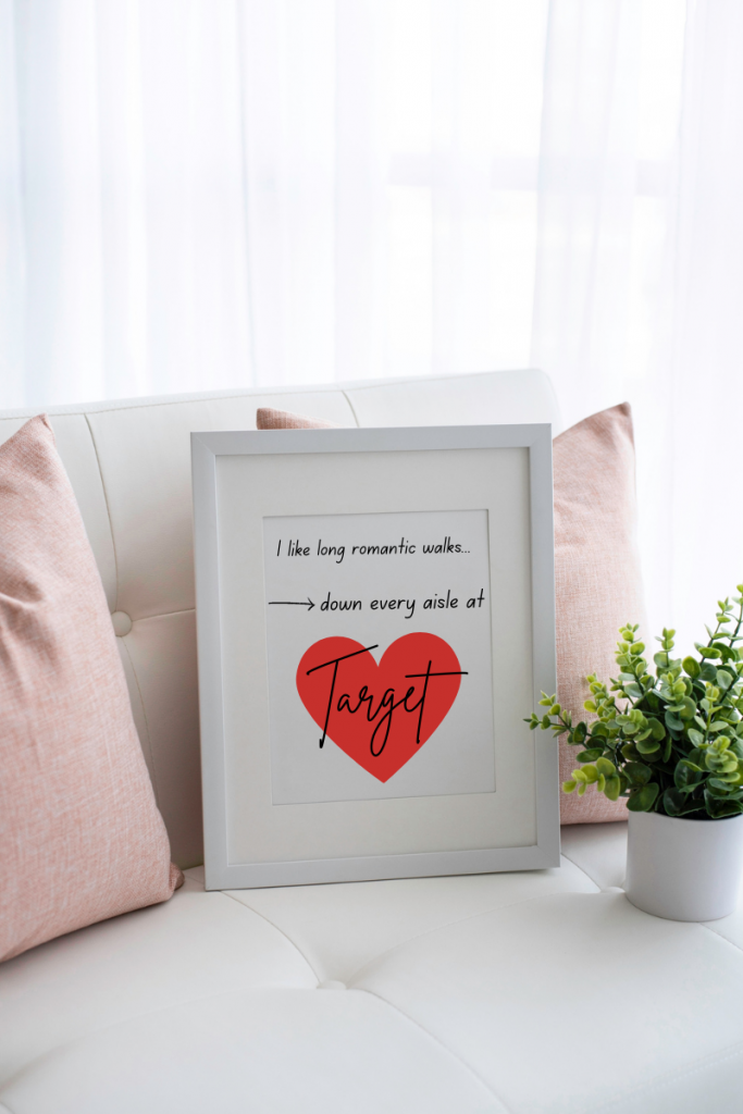 A photo on a couch styled with pillows and an accent plant