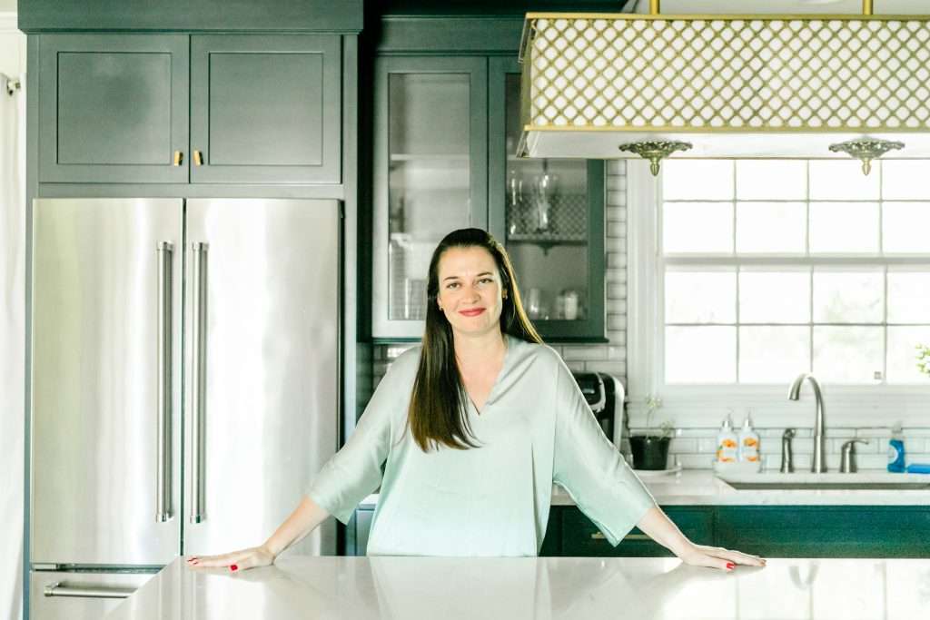 A woman standing in a kitchen