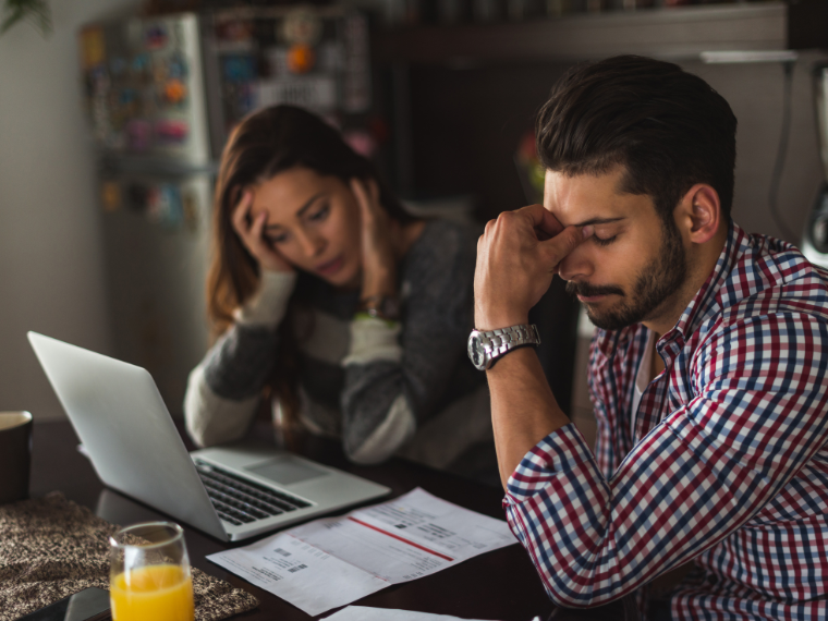 A couple at a computer in distress