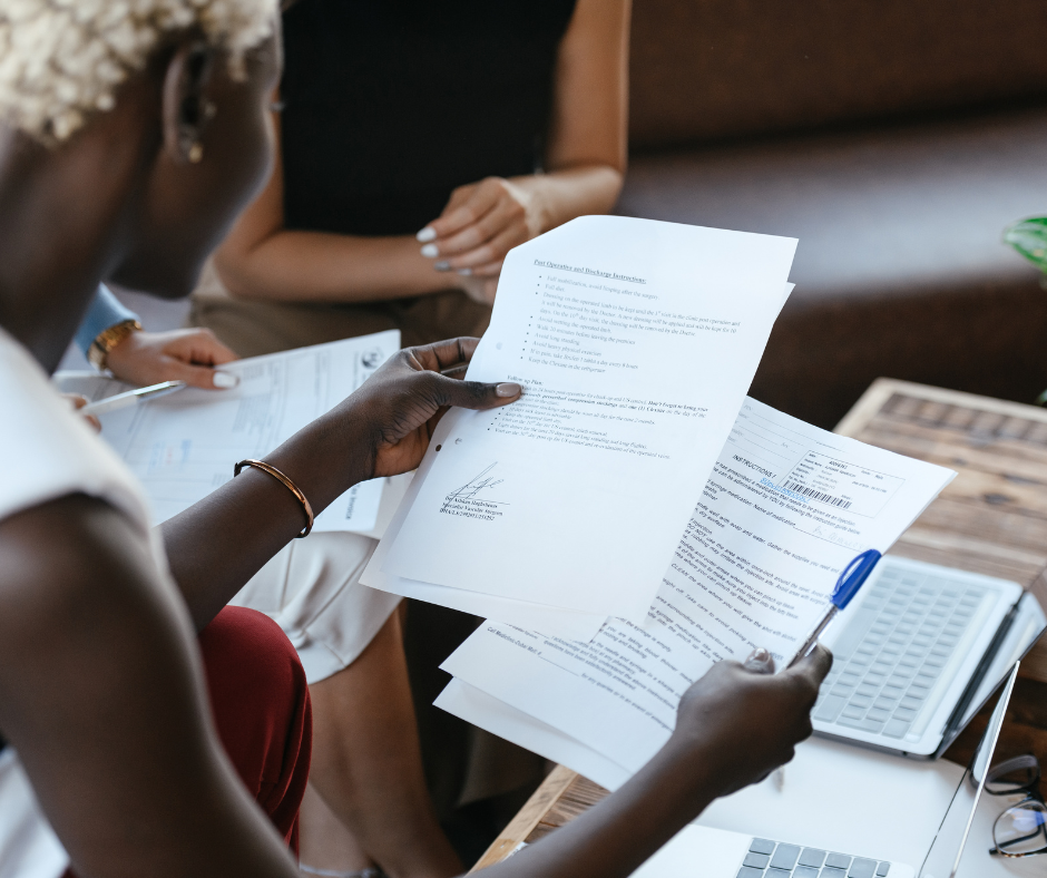 A woman reading documents to financially prepare for divorce